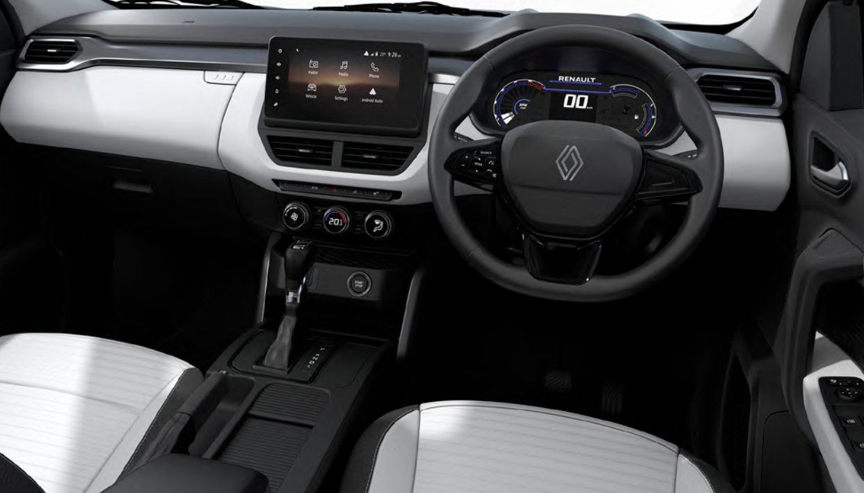 Renault Kiger interior showing steering wheel, digital dashboard, touchscreen, and white-black upholstery.