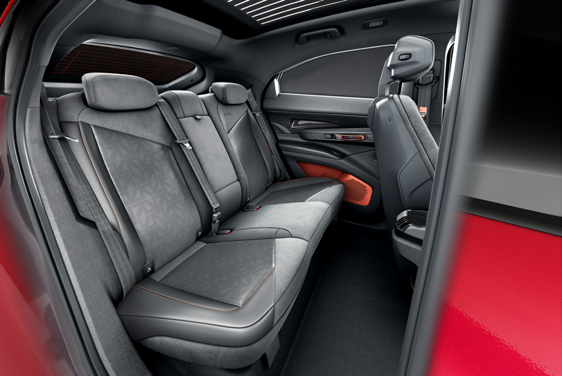 Mahindra BE 6 FE — Rear seats in leatherette and suede with Formula E logo pattern and Firestorm Orange translucent door inserts