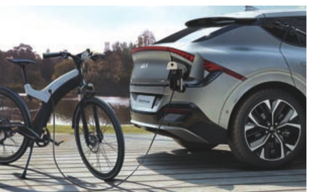 Kia EV6 — Vehicle-to-Load (V2L) powers external devices, here charging an e-bike from the EV6's charge port.