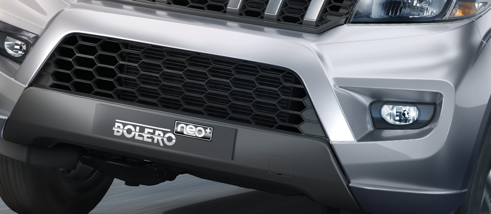 Mahindra Bolero Neo Plus — Signature X-shaped front bumper with honeycomb inserts and front fog lamps