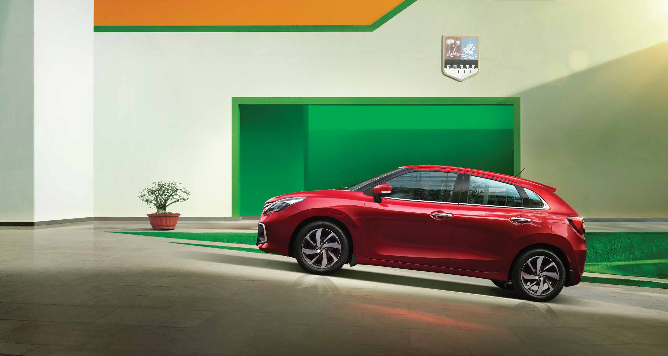 Toyota Glanza — Flowing side profile riding on dual-tone precision-cut alloy wheels.