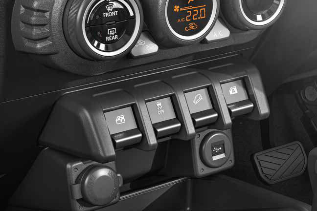 Maruti Suzuki Jimny — Centre-console switches for hill descent control and ESP off, with a USB charging port.
