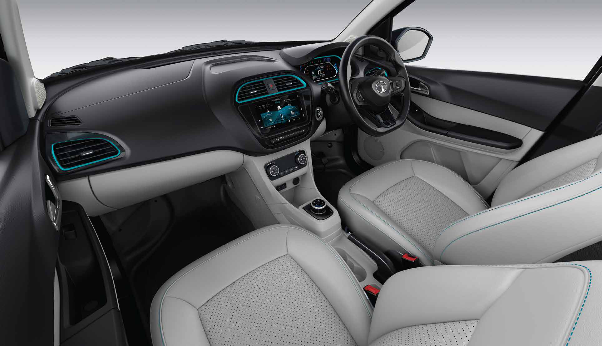 Tata Tigor EV — Dual-tone dashboard with EV-blue accents around the AC vents, floating touchscreen and digital instrument cluster