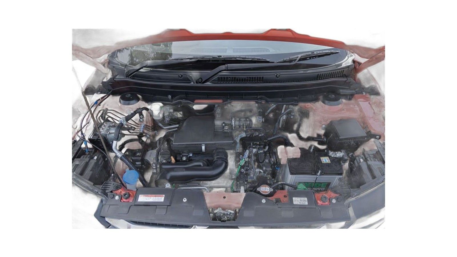 Engine compartment of red Maruti Suzuki Brezza with hood open, showing motor and components.