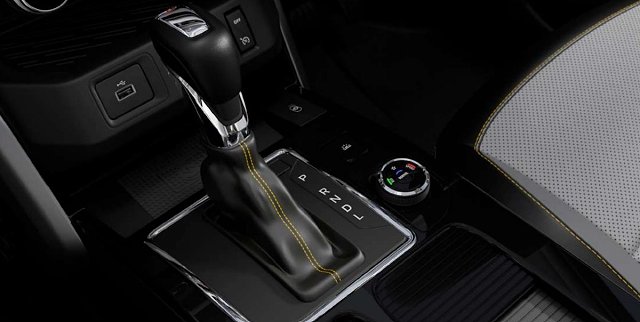 Car interior showing automatic transmission shifter, steering wheel, and dashboard controls.