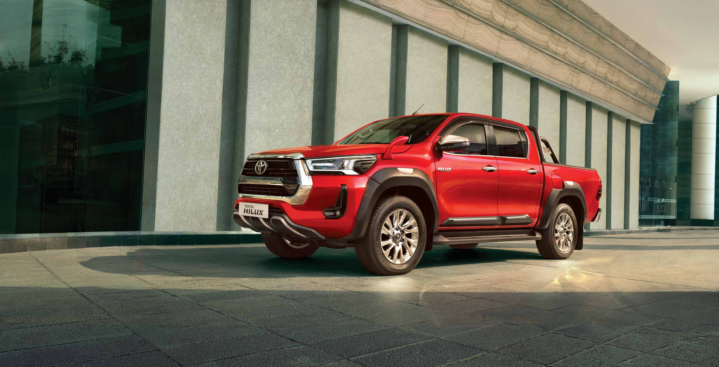 Toyota Hilux (2022-2025) — Muscular double-cab profile riding on machined-finish alloy wheels.