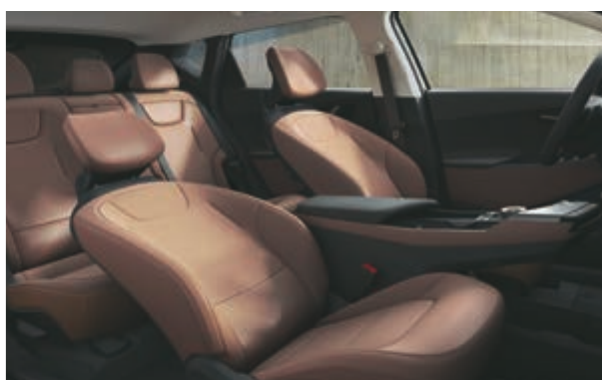 Kia EV6 — Driver and front-passenger premium relaxation seats in tan upholstery.