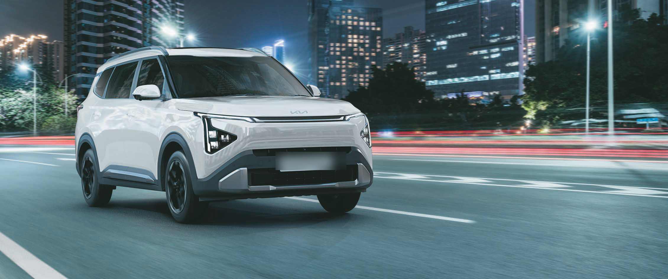 Kia Carens Clavis — Illuminated Star Map LED headlamps and light bar on the front fascia at night