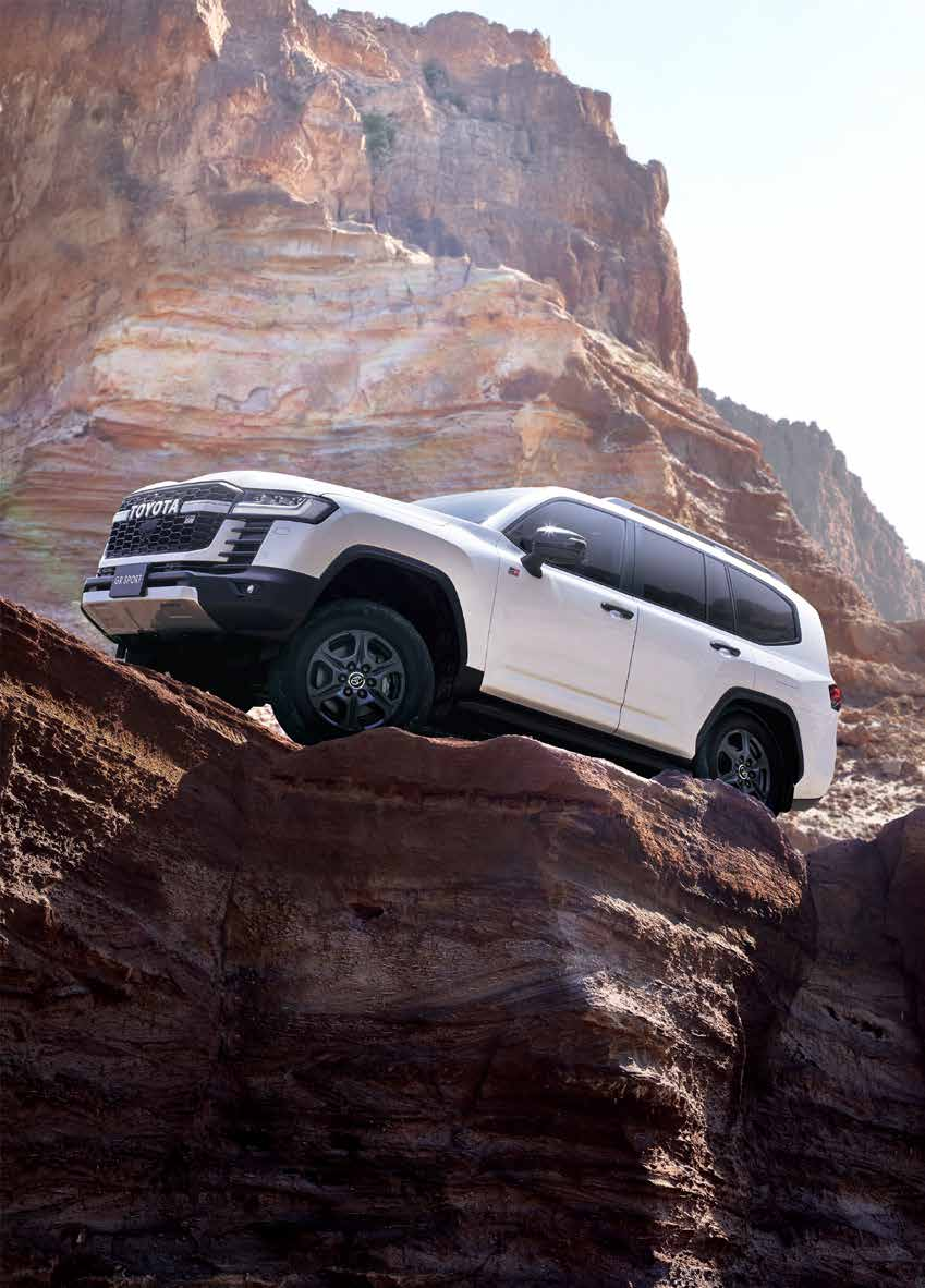 Toyota Land Cruiser — Four-wheel drive tackling a steep rock climb