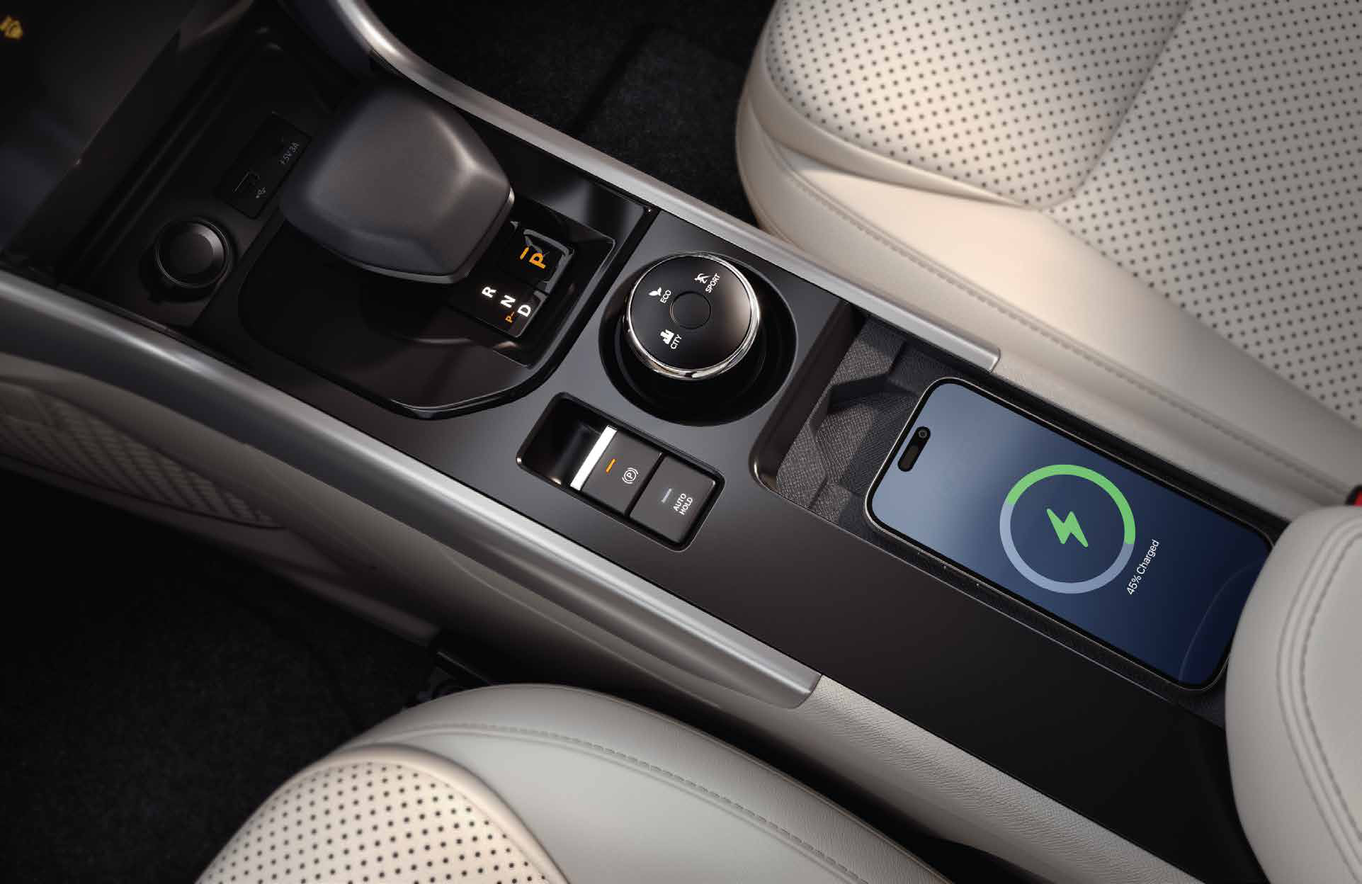 Tata Curvv — Smart e-shifter for the 7-speed DCA with a rotary multi-drive-mode selector and electronic parking brake with auto hold; wireless smartphone charger sits alongside.