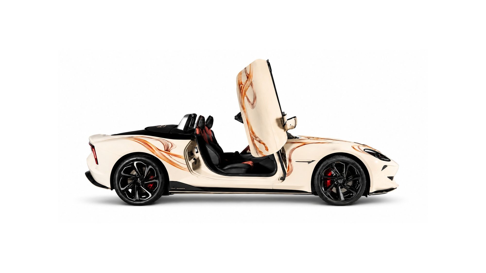 MG Cyberster — Cyberster Couture Edition — white body with orange 'Serpent Infinity' streaks, gold MG emblems and an embroidered tonneau cover, designed with couturier Gaurav Gupta. Limited to 50 units at ₹87.49 lakh (ex-showroom), sold only through MG Select.