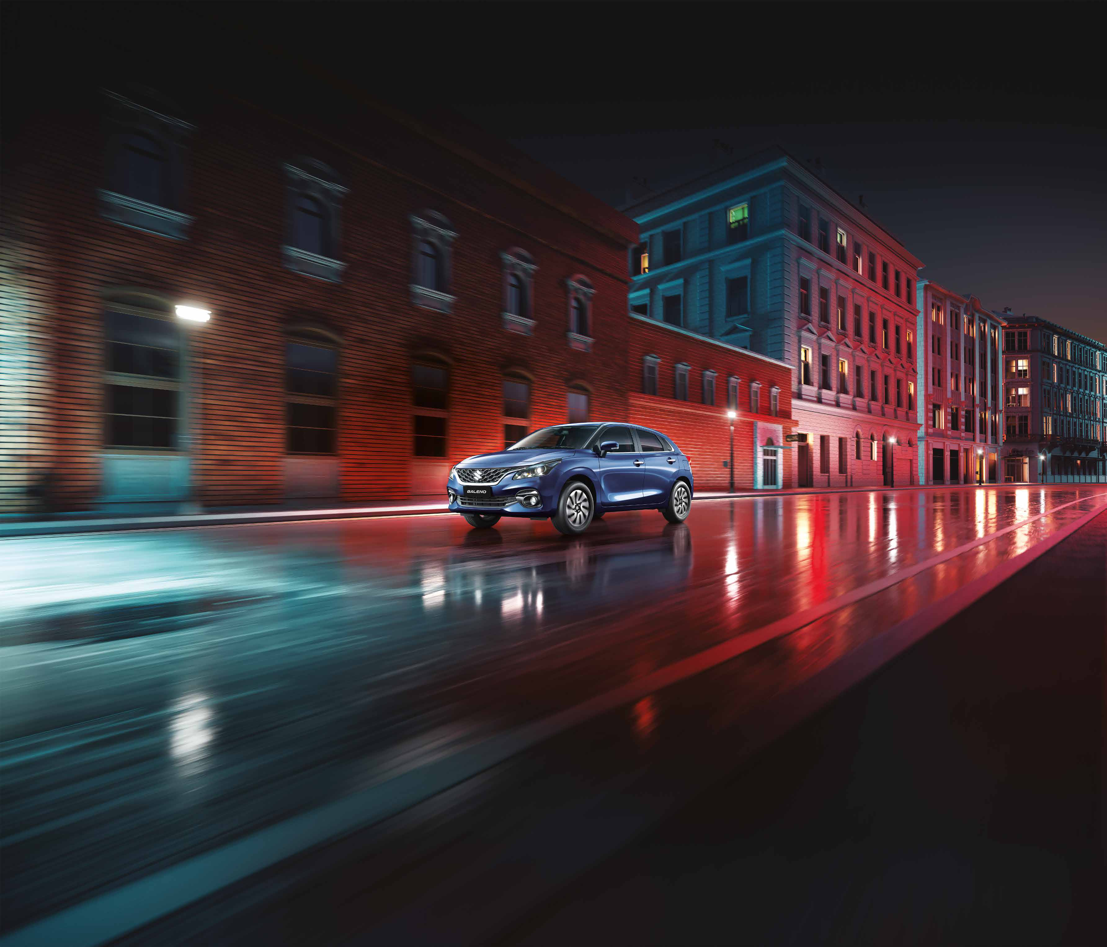Maruti Suzuki Baleno — Front three-quarter profile of the New Age Baleno showing the NEXWave grille and LED projector headlamps.