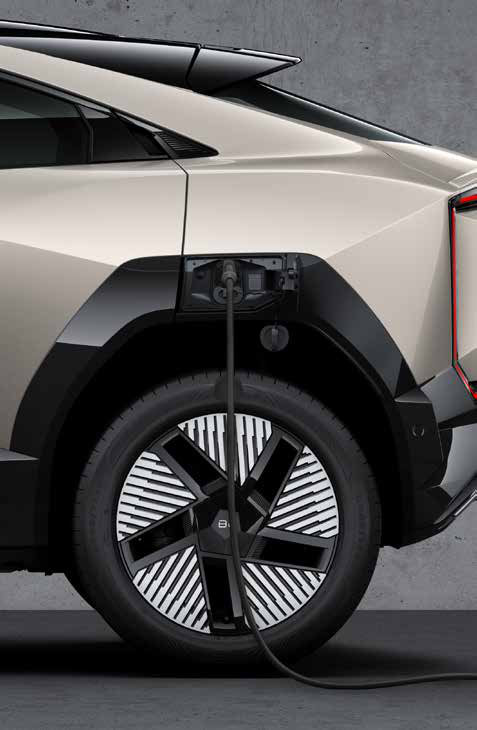 Mahindra BE 6 — Side charging port shown with the connector plugged in for DC fast charging