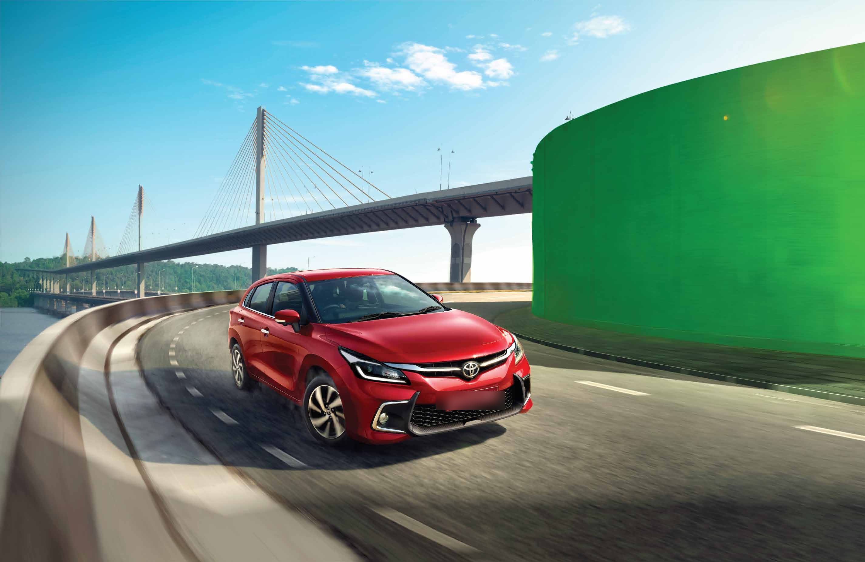Toyota Glanza — The Glanza on the move, highlighting its planted stance and aerodynamic silhouette.