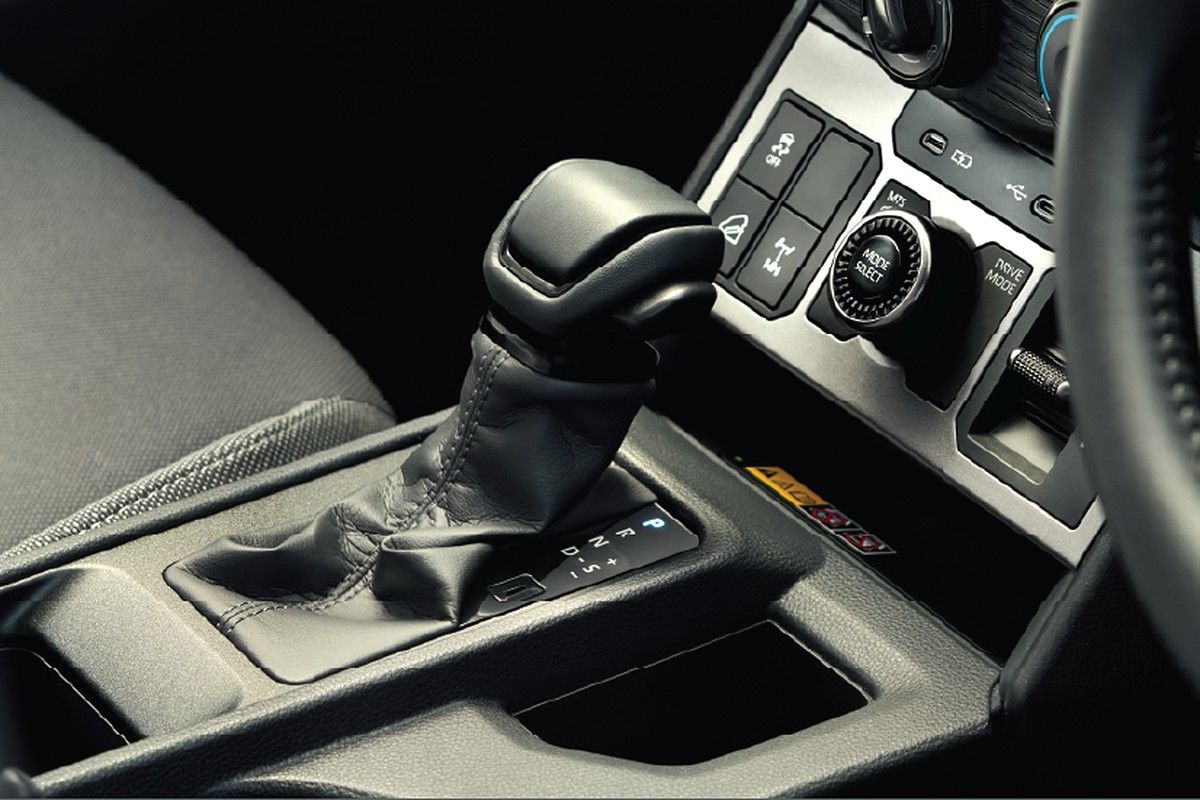 Toyota Hilux — Redesigned cabin with leather-wrapped gear lever and drive-mode/4WD controls.