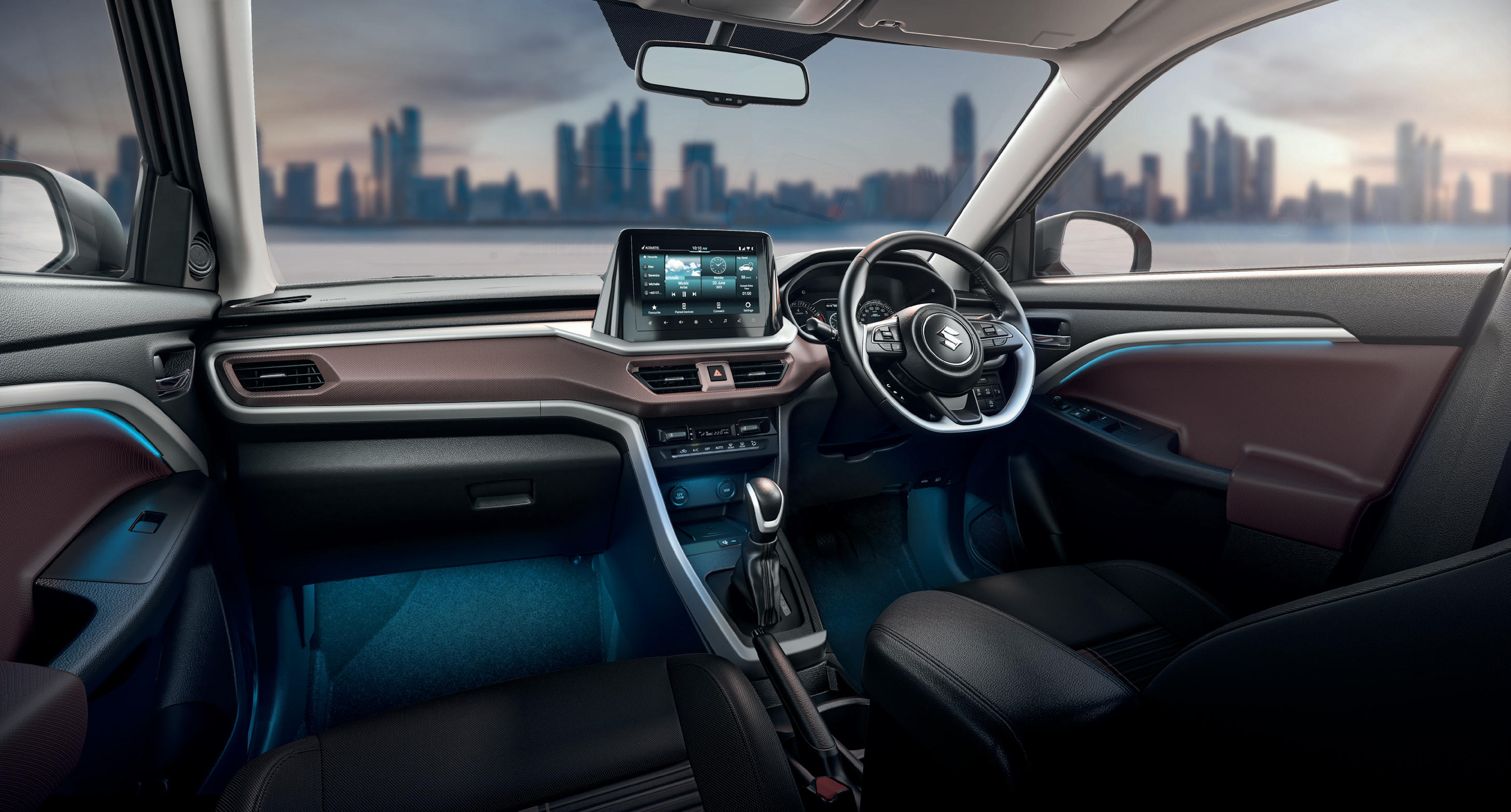 Maruti Suzuki Brezza (2022-2025) — Dual-tone black and brown cabin with silver accents, ambient lighting and floating touchscreen.