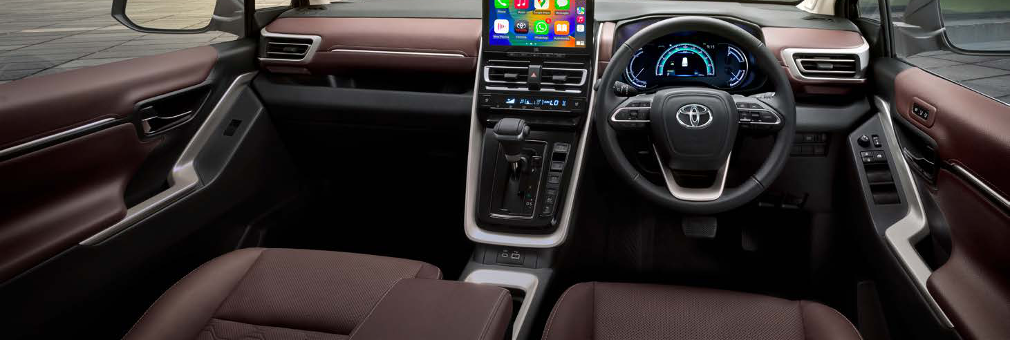 Toyota Innova Hycross — Dark-chestnut dual-tone dashboard with a free-standing touchscreen and digital cluster