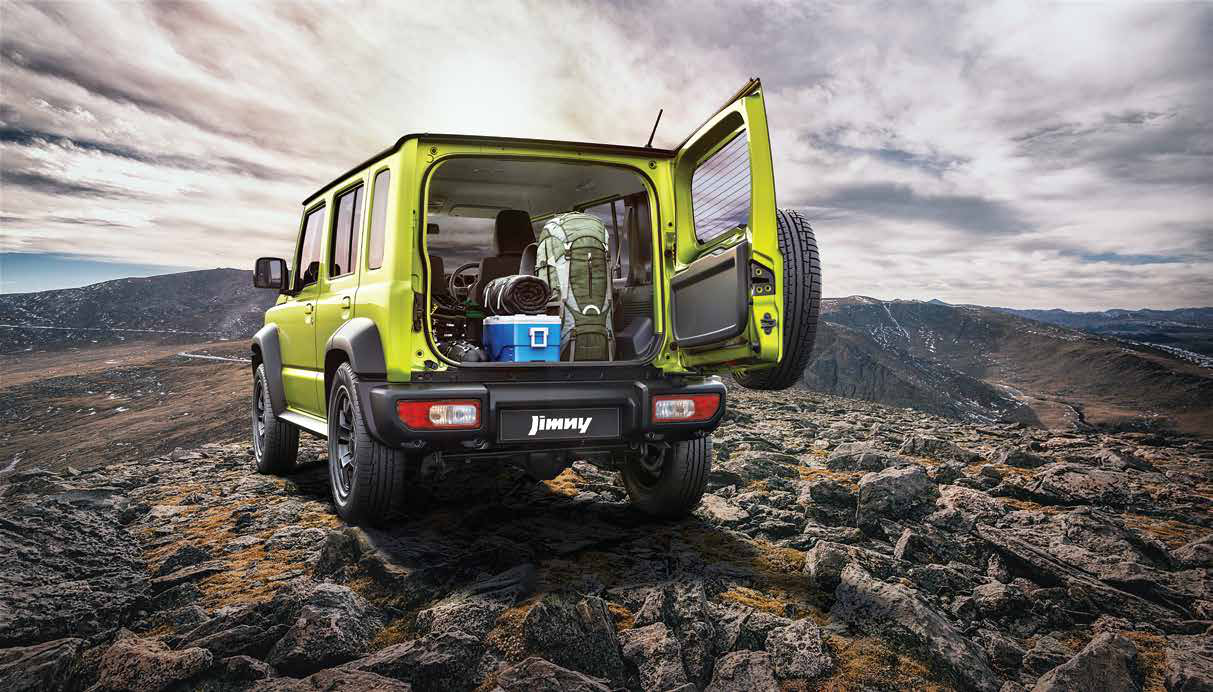 Maruti Suzuki Jimny — Side-hinged rear tailgate swings open to a flat, gear-friendly luggage bay.