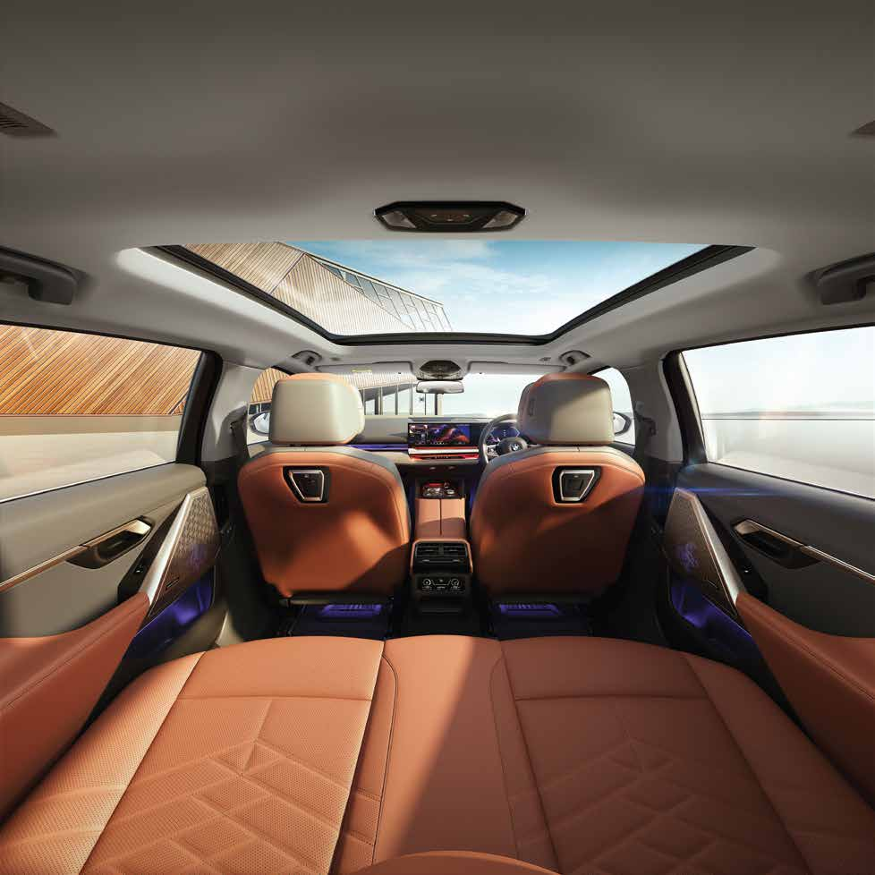 BMW 5 Series  — Sculpted front seats beneath the panoramic glassroof, with the wide dashboard display