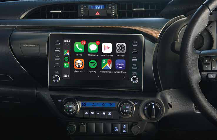 Toyota Hilux (2022-2025) — Touchscreen with smartphone connectivity above dual-dial climate controls.
