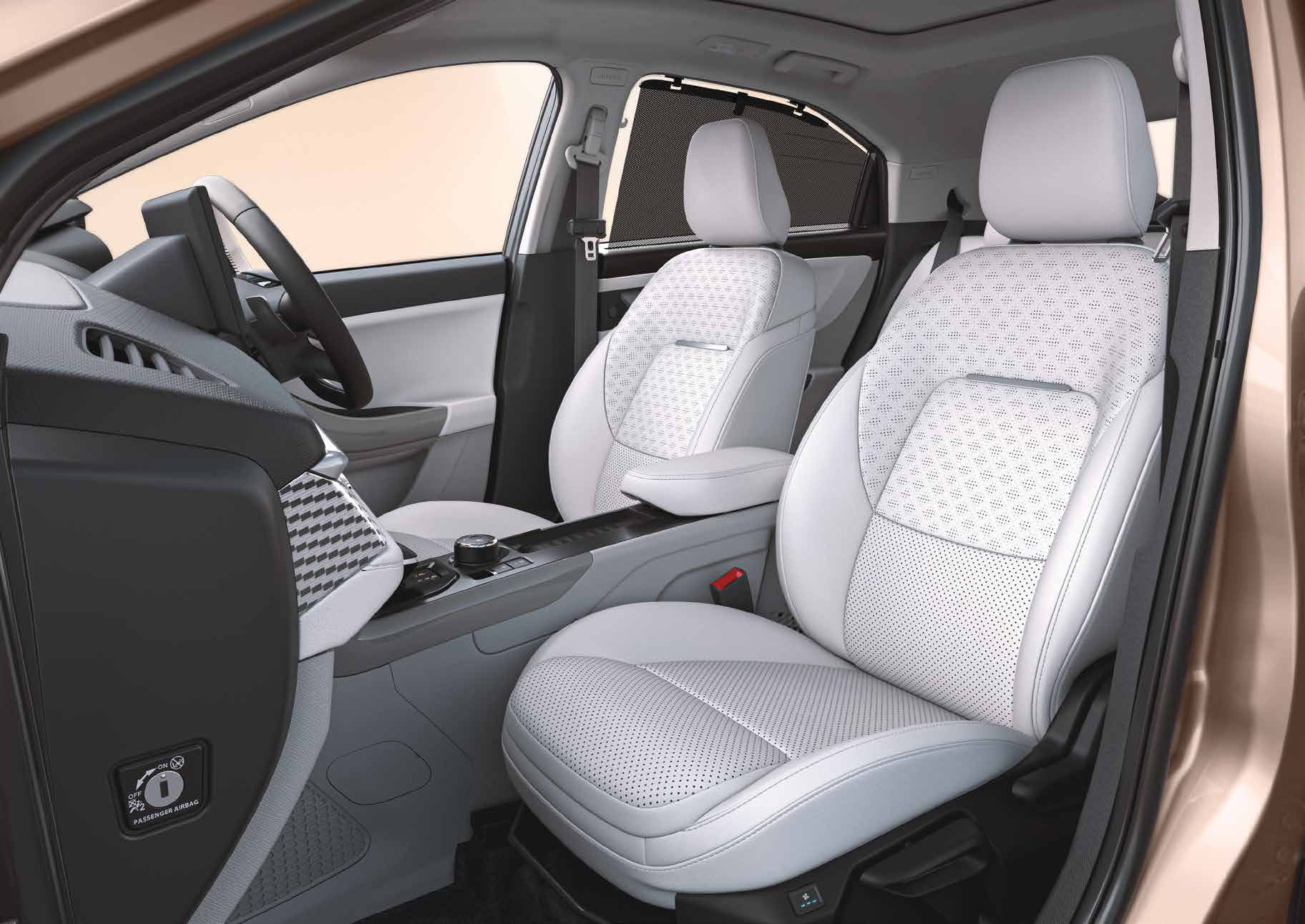 Tata Curvv — Persona-themed interiors — a light dual-tone cabin with perforated upholstery and geometric console inserts.