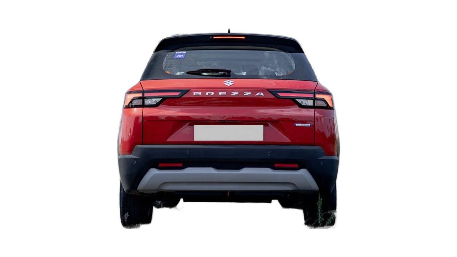 Red Maruti Brezza SUV rear view with black roof and gray bumper skid plate.