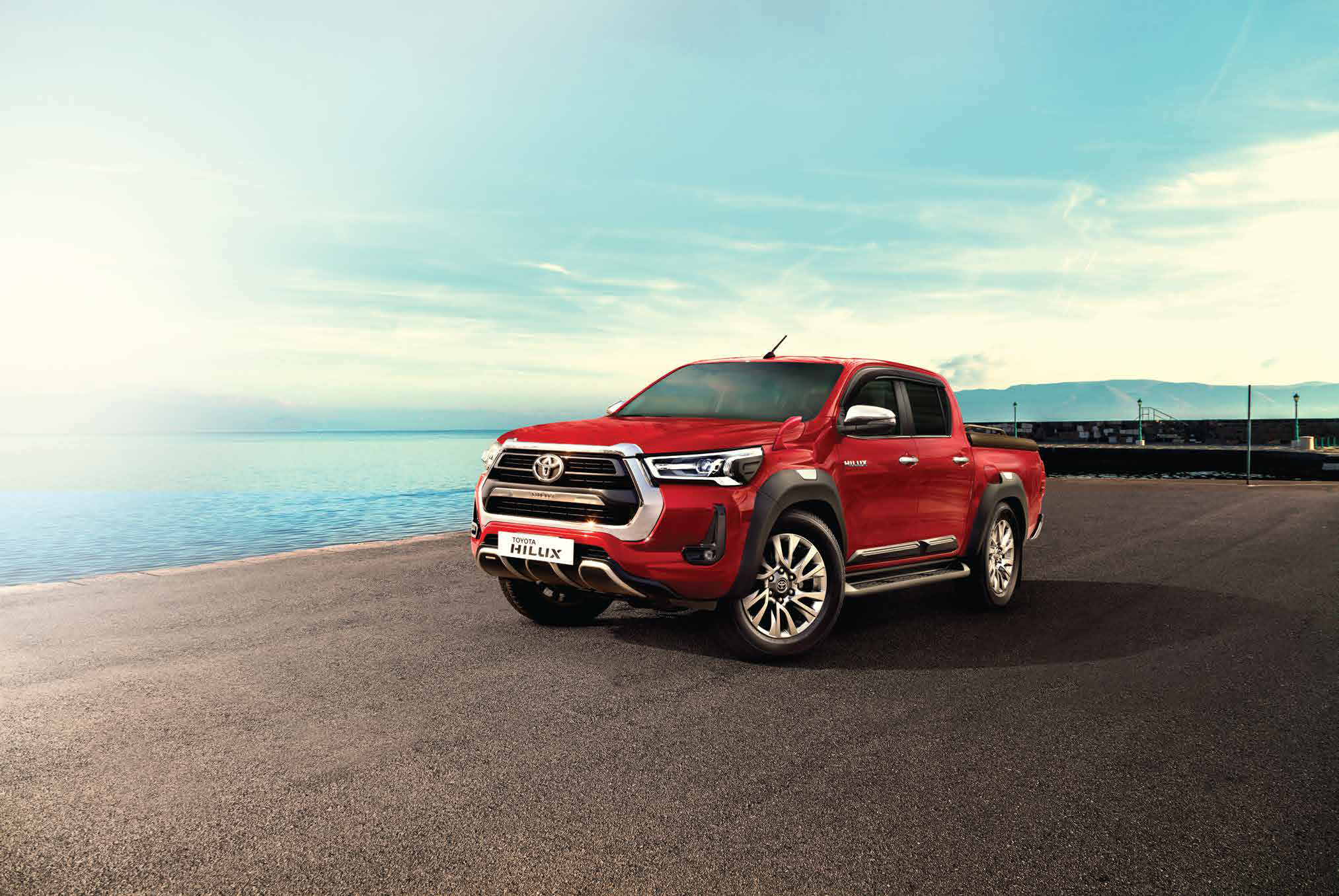 Toyota Hilux (2022-2025) — LED headlamps flank the bold chrome front grille of the double-cab Hilux.