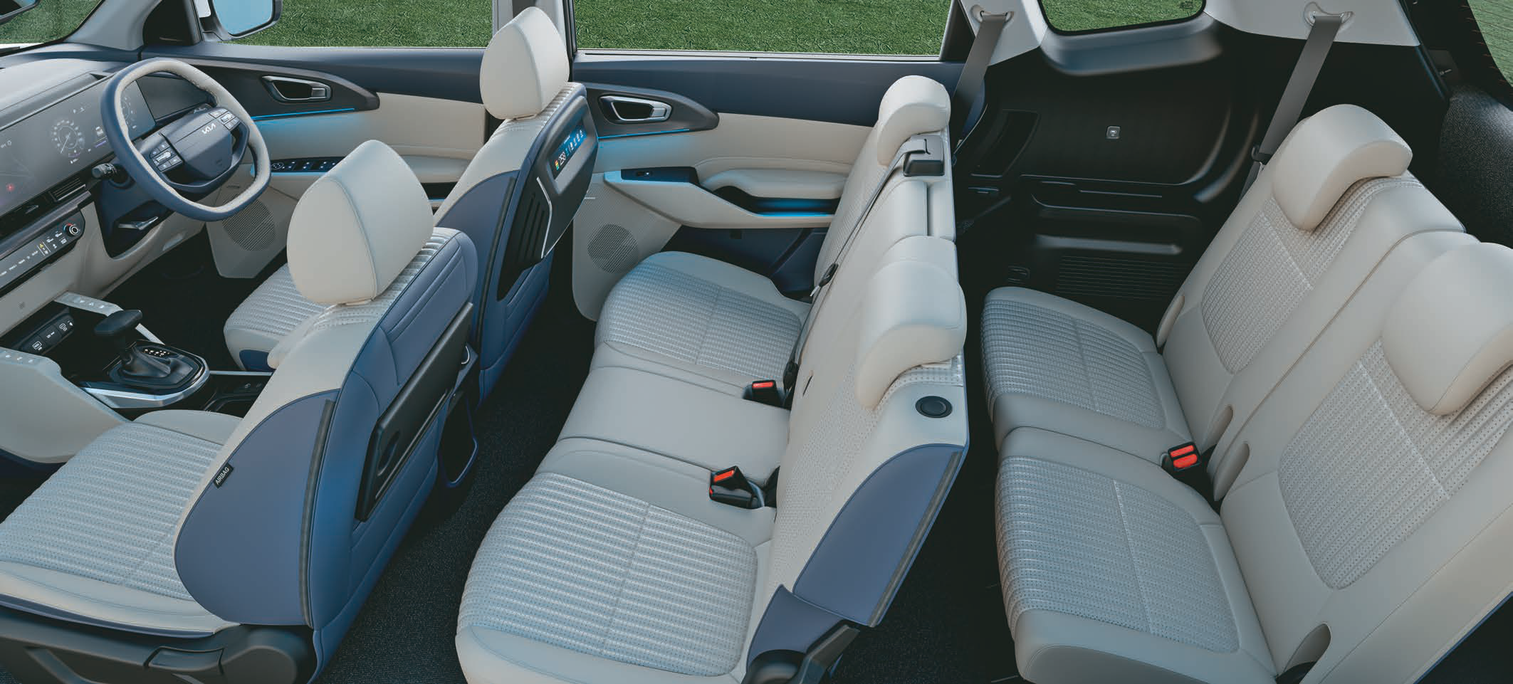 Kia Carens Clavis — Three-row cabin with dual-tone beige and navy leatherette upholstery