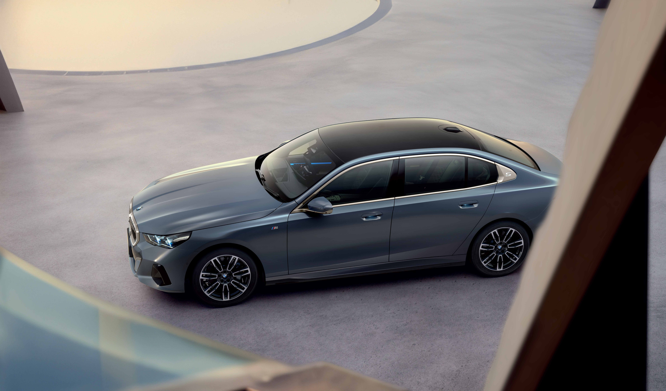 BMW 5 Series  — Full-length panoramic glass roof and the embossed '5' on the C-pillar, viewed from above