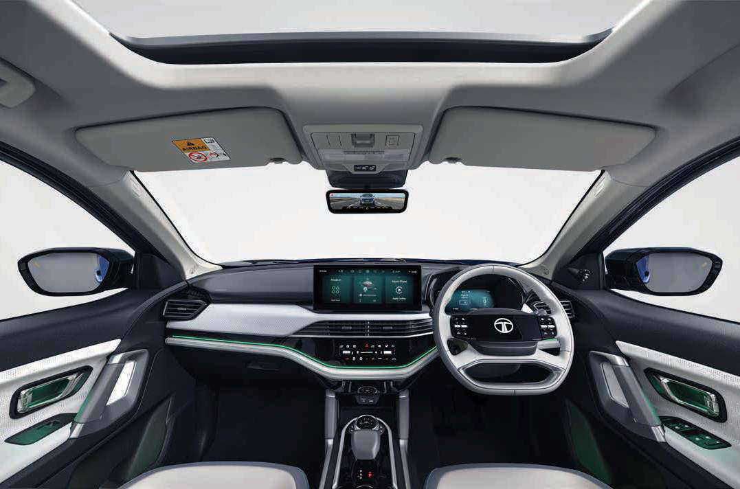 Tata Harrier EV — Dual-tone dashboard with layered dual screens, ambient light line and panoramic roof overhead