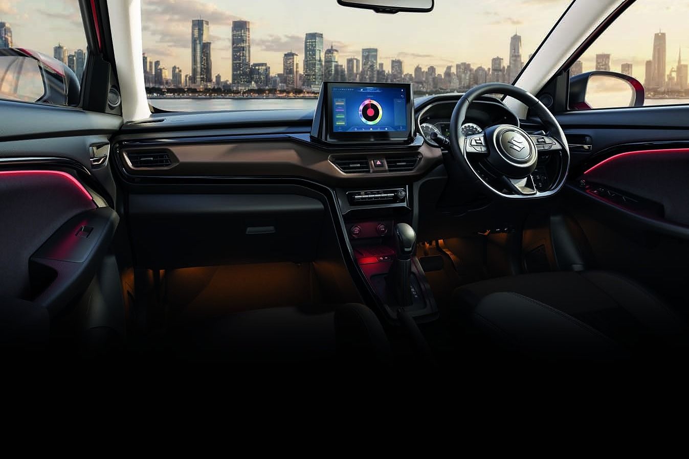Maruti Suzuki Brezza — Dark brown and black cabin with a flat-bottom leather-wrapped steering wheel, floating touchscreen and 64-colour ambient lighting.