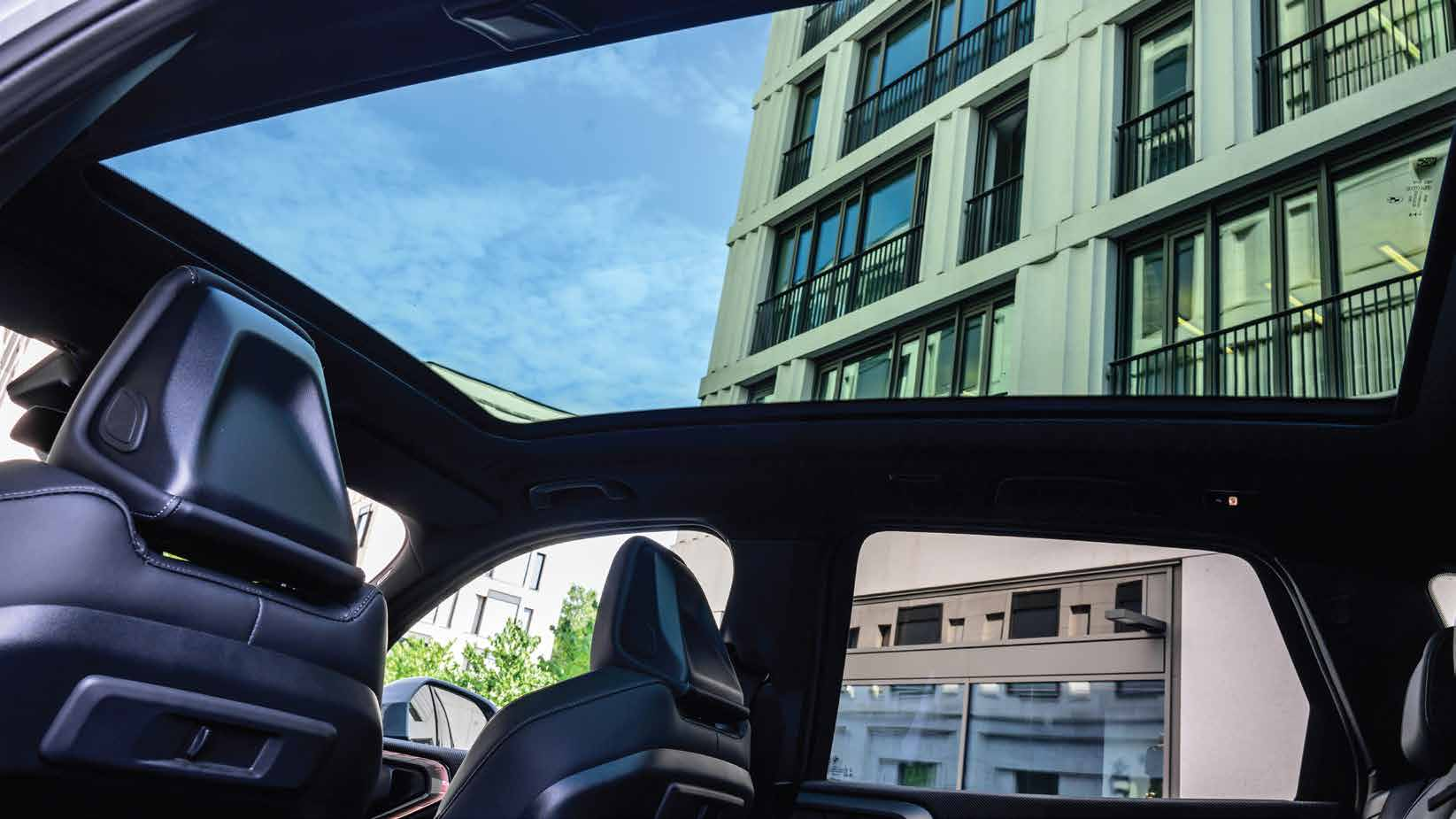 BMW X3 — Panoramic glass roof stretching edge to edge over the cabin