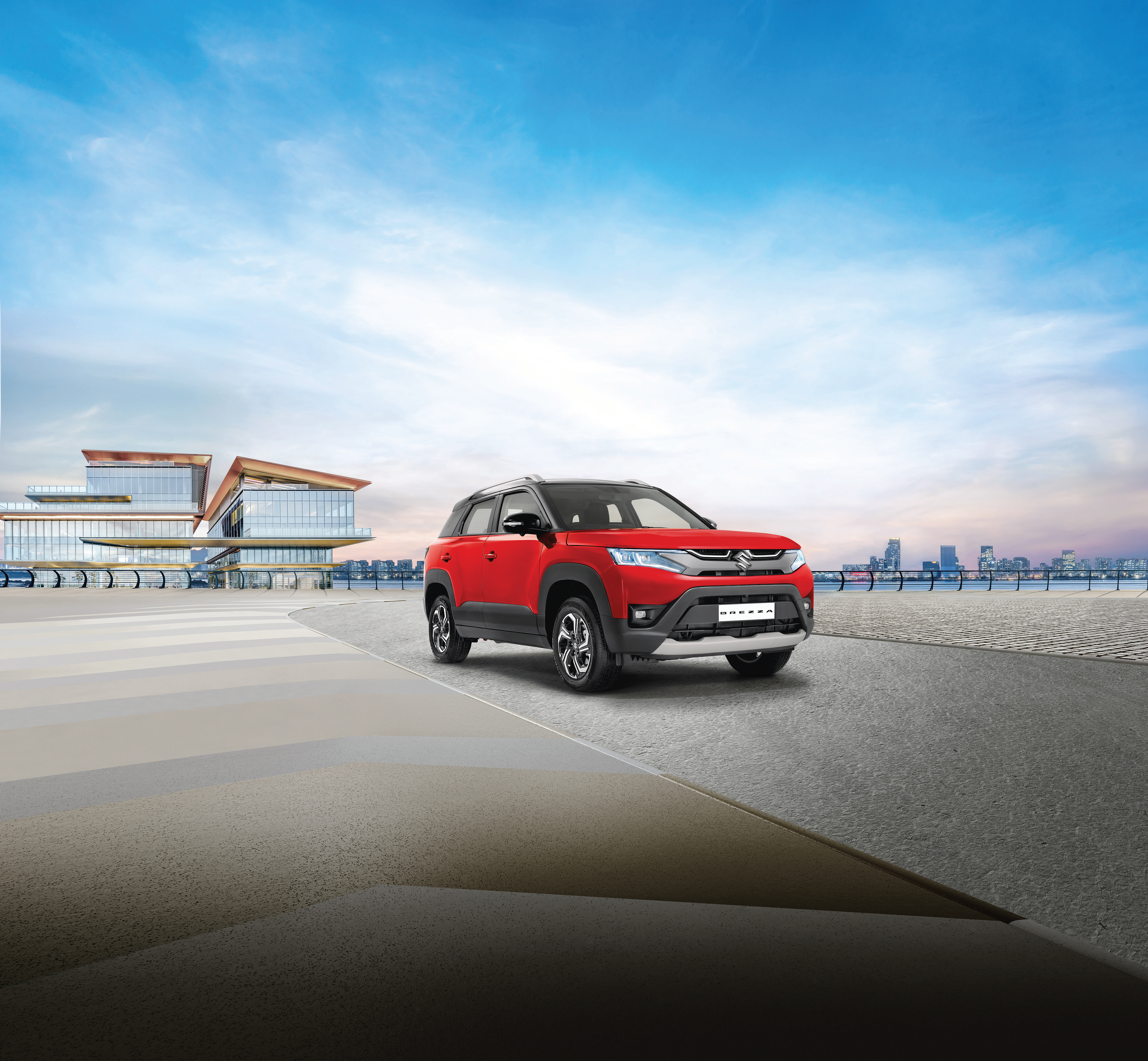 Maruti Suzuki Brezza (2022-2025) — Front three-quarter stance with dual-tone roof, LED projector headlamps and body cladding.