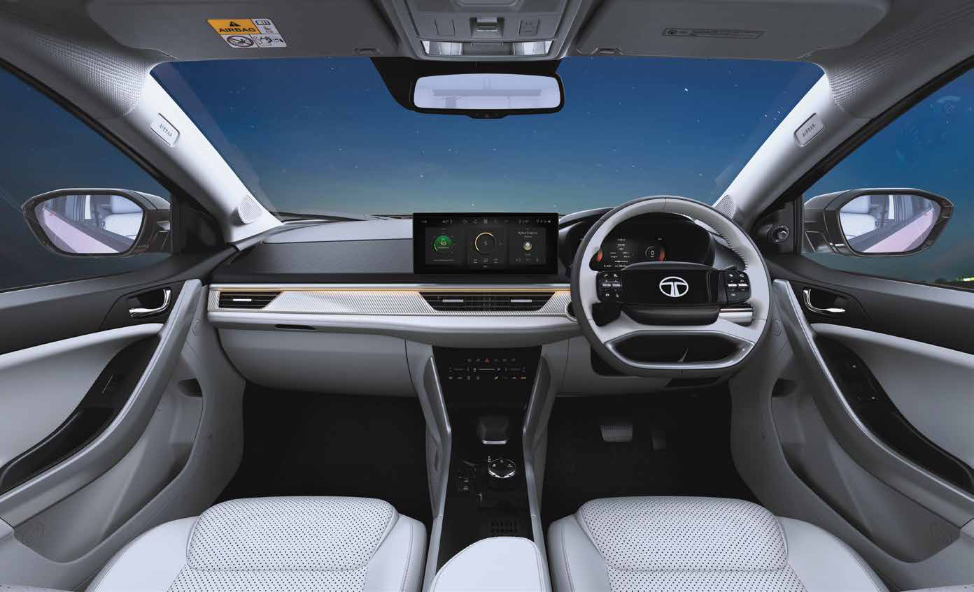 Tata Curvv — Themed illuminated dashboard with mood lighting, paired with a 4-spoke illuminated digital steering wheel.