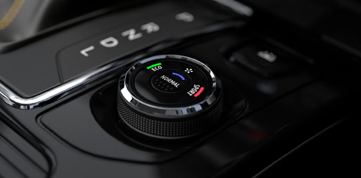 Rotary dial control with ECO, Normal, and Sport driving modes in vehicle interior.