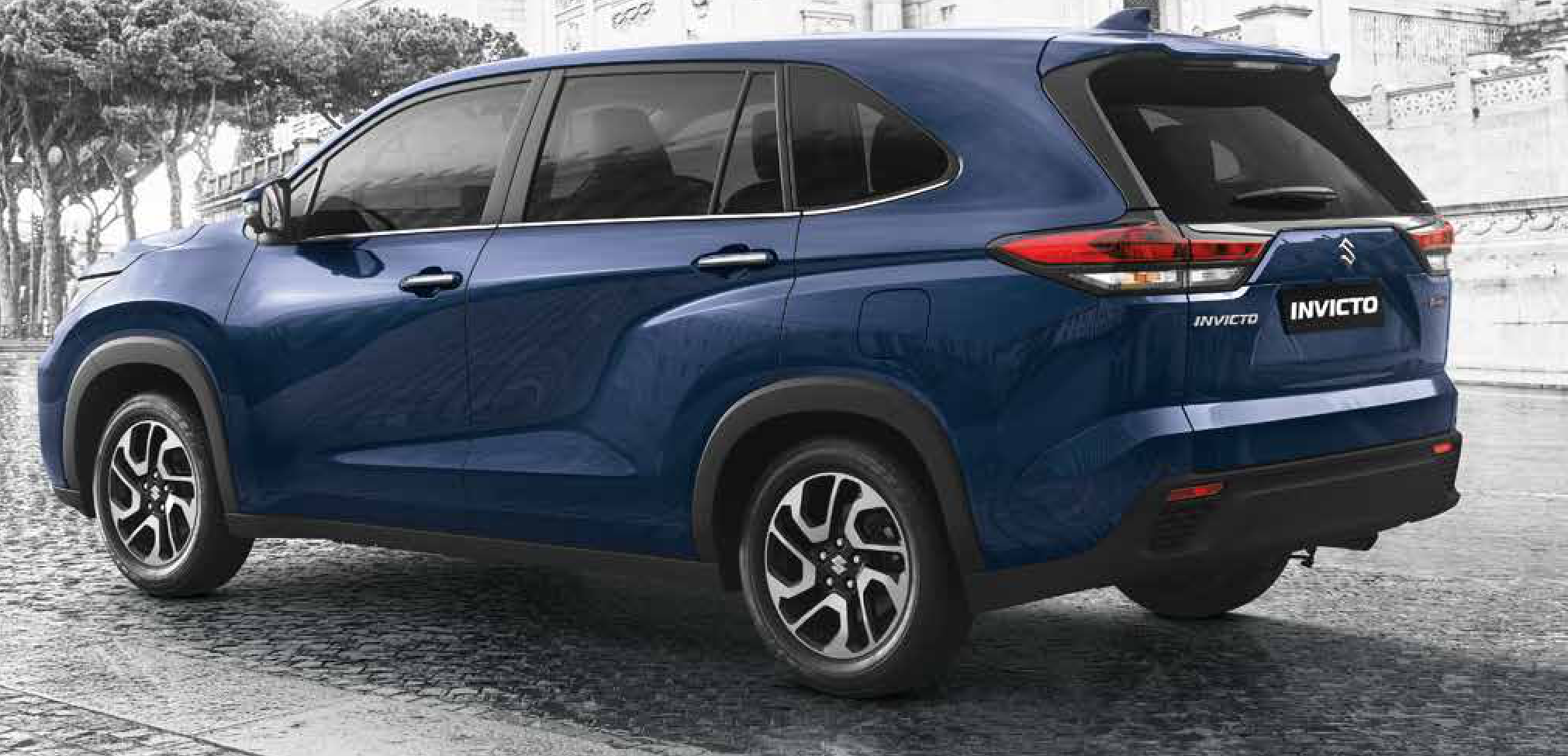 Maruti Suzuki Invicto — Rear three-quarter profile with NEXTre signature LED tail lamps and a chrome tailgate insert.