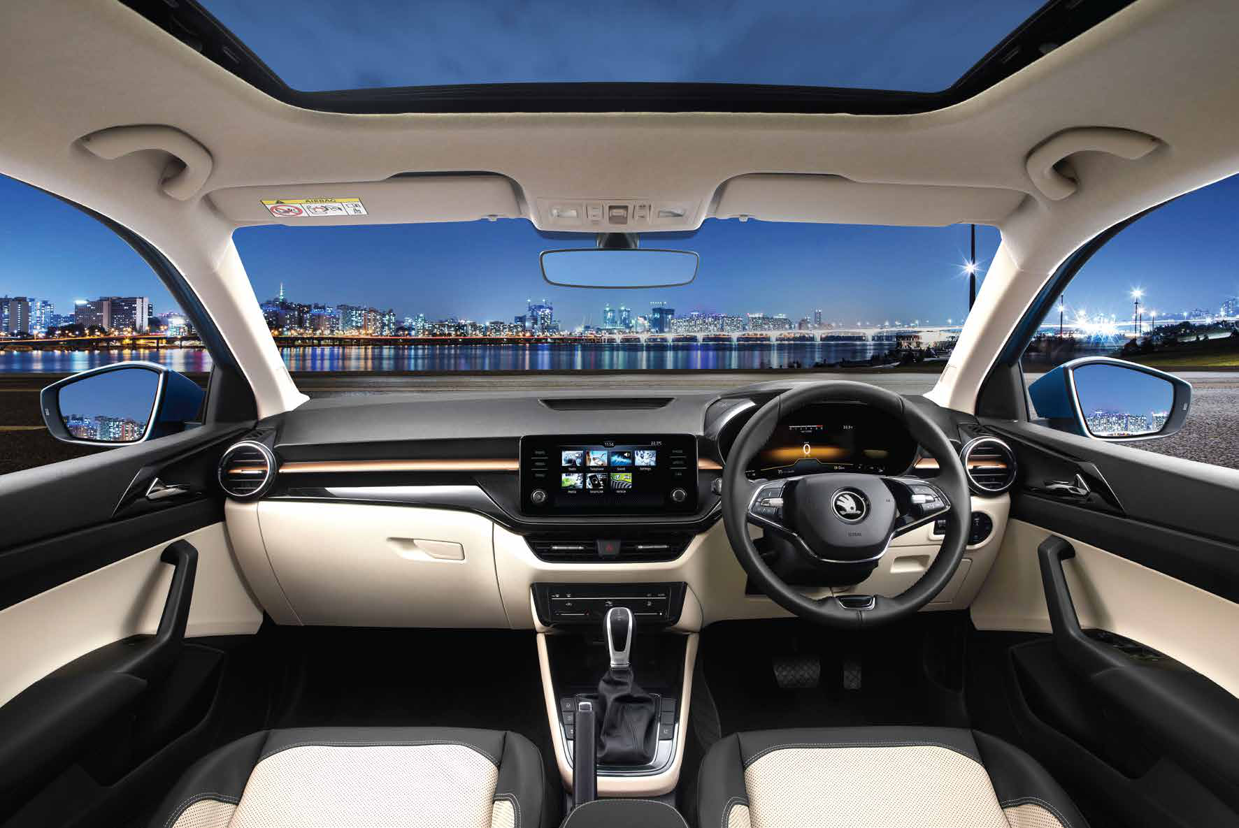 Skoda Slavia — Stone Beige and Piano Black dashboard with an electric sunroof opening to a panoramic cabin view.