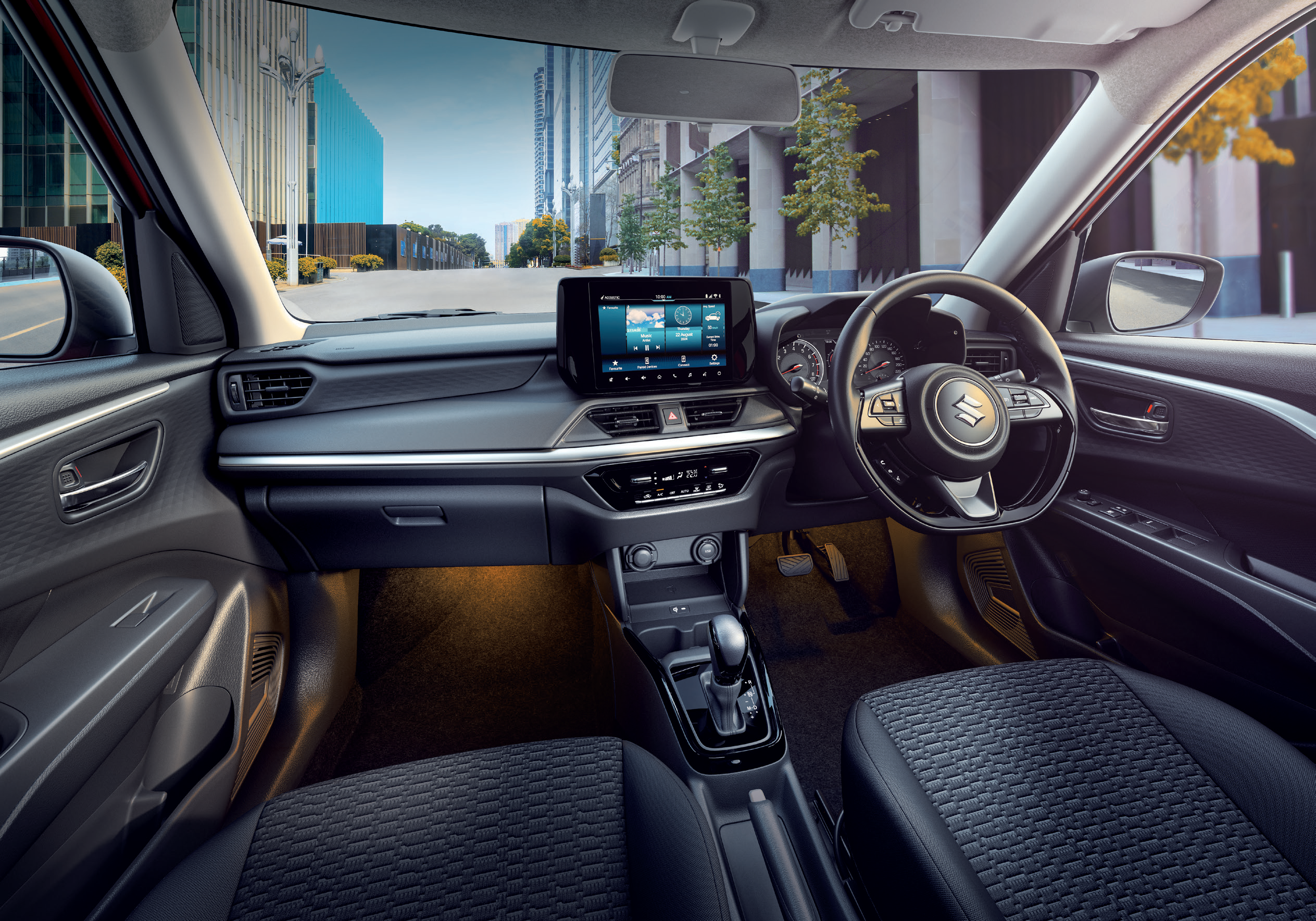 Maruti Suzuki Swift — All-black driver-oriented dashboard with floating touchscreen and flat-bottom steering wheel
