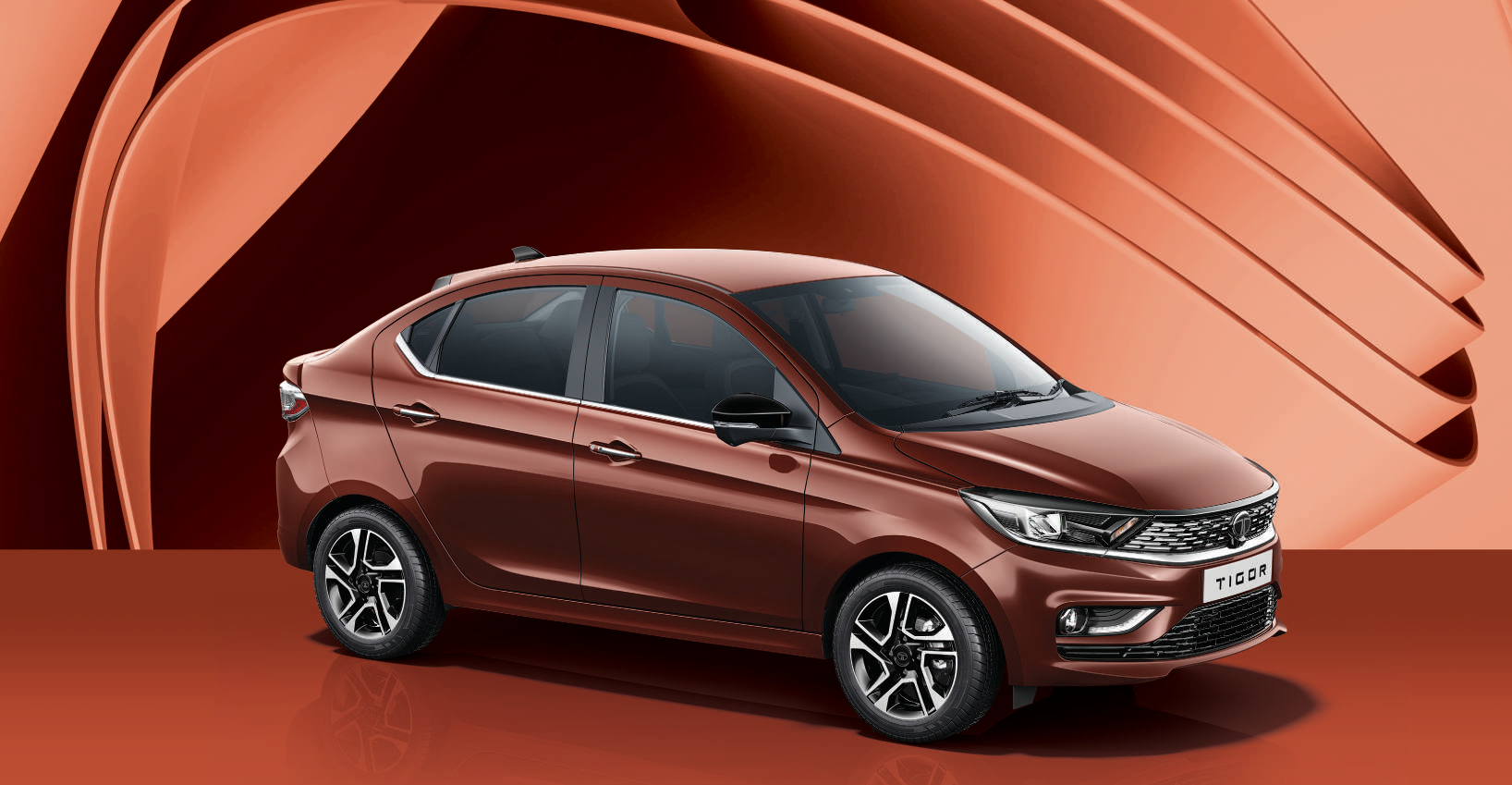 Tata Tigor — Sedan stance with coupe-style sweeping roofline, chrome window-line finish and boot lip spoiler