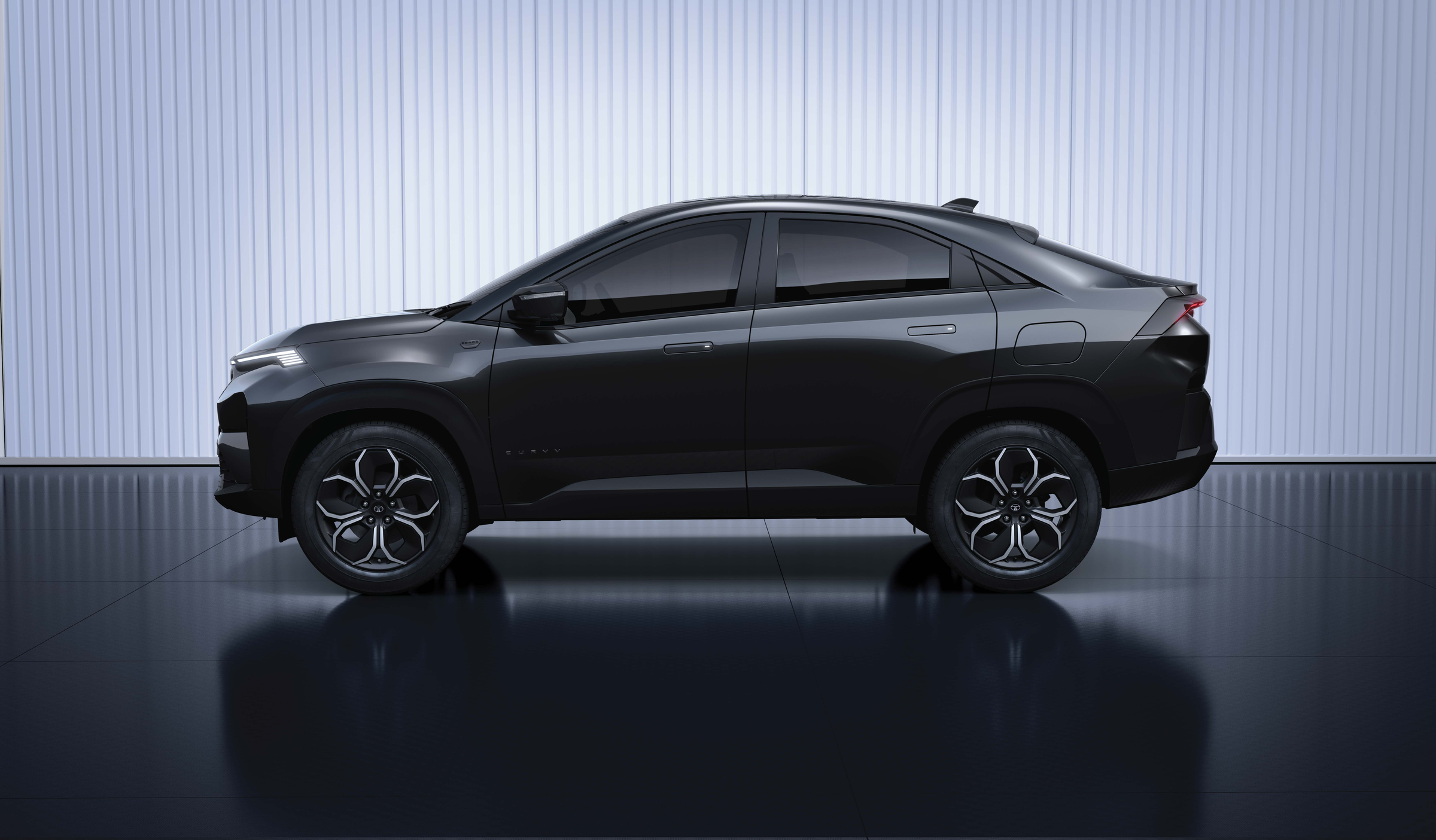 Tata Curvv — #DARK edition in Carbon Black with R18 #DARK diamond-cut alloy wheels and blacked-out exterior detailing.
