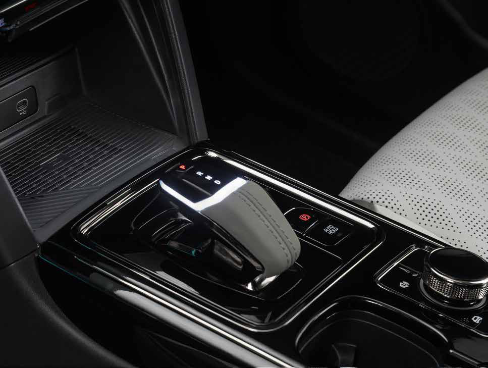 Mahindra XEV 9e — Floating centre console with a leatherette e-shifter and wireless phone charger
